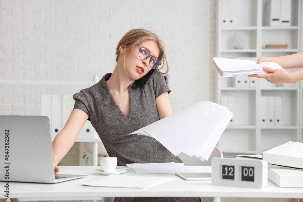 Canvas Prints young businesswoman working with documents under deadline in office