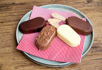 Ice cream sticks with chocolate and almonds