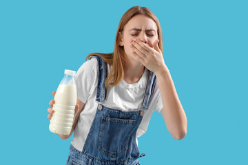 Young woman with lactose intolerance on blue background