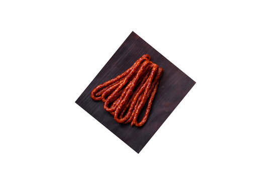 Delicious thin smoked meat sausages with spices and herbs