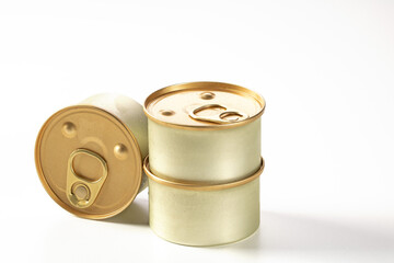 Three metal jars with cat food on a white background