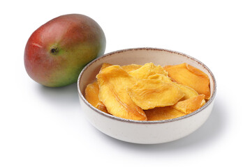 Bowl with slices of tasty dried mango and ripe fruit on white background