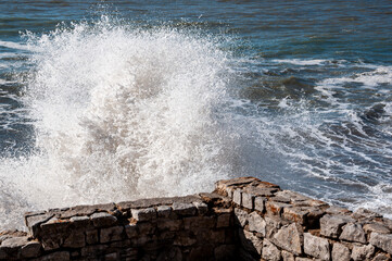 sea waves crashing on shoreline rocks	