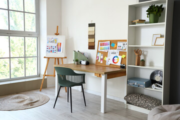 Interior designer's workplace with pin board in office