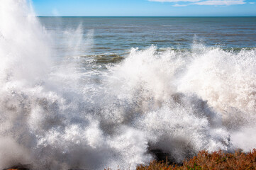 sea waves crashing on shoreline rocks