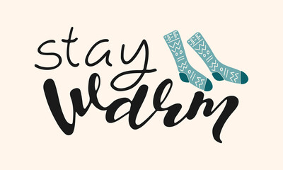 Stay warm handwritten lettering phrase. Seasonal composition with hand drawn inscription and warm socks. Winter autumn cozy background. Design element