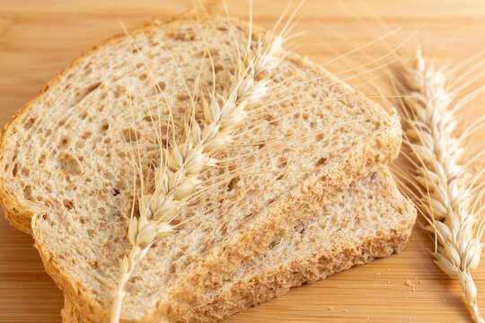 Ears of wheat and slices of bread. Food shortage, food crisis, climate change, food, grain, famine, drought, nutrition concept.