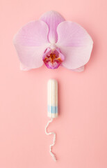 Hygienic tampon on a pink background. Feminine hygiene products.