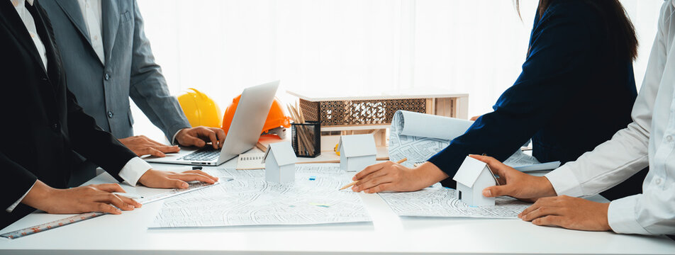 Worker, architect and engineer work on real estate construction project oratory planning with cartography and cadastral map of urban town area to guide to construction developer business plan of city