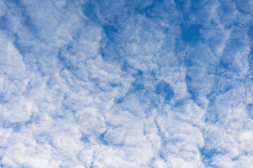 textured white clouds on the blue sky.