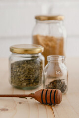 Close up of honeycomb stick with glass ingredients containers