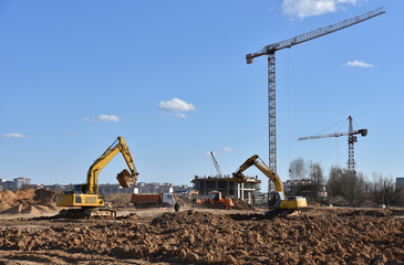 Excavator dig ground at construction site. Dig foundation. Construction of residential buildings and renovation. Earthmover on groundwork. Excavator on earthmoving. Loader on dredging and trenching.