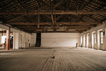 Very old abandoned factory warehouse with wooden floors and windows and clay tiles.