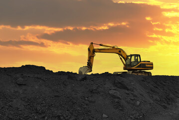 Coal mining. Excavator on earthmoving at open pit mining. Backhoe dig ore in quarry on sunset....