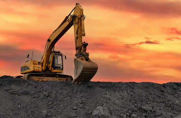 Coal mining. Excavator on earthmoving at open pit mining. Backhoe dig ore in quarry on sunset....