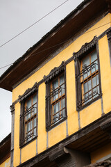 Old doors and windows damaged from weather in ancient city of Gjirokaster in Albania exploring Balkan stock photography travel high quality big size instant print