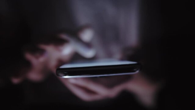 Late-Night Web Browsing: Man Indoors, Scrolling on Phone