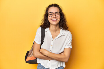 Caucasian university student with glasses, backpack, laughing and having fun.