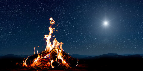Naklejka premium A christmas star shines at night over the mountains of Bethlehem