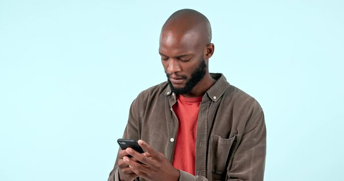 Wow, fake news and black man with phone in studio for scam, notification or phishing on blue background. Wtf, stress and African male model with smartphone glitch, error or social media hacker alert