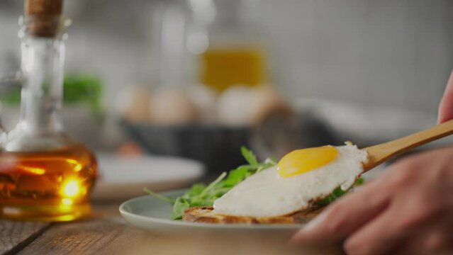 Fry. Woman cook in chef's clothes having breakfast with scrambled eggs in home kitchen. Camera in motion dieting girl in the morning preparing breakfast preparing a healthy fried breakfast