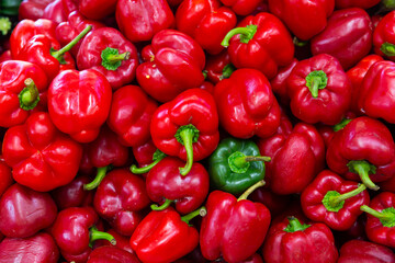 Closeup of ripe red and green bell peppers on the farmer's market