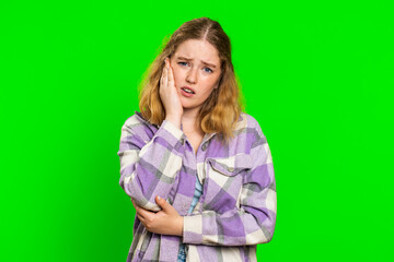 Dental problems. Young woman touching cheek, closing eyes with expression of terrible suffer from painful toothache, sensitive teeth, cavities. Pretty redhead girl isolated on chroma key background