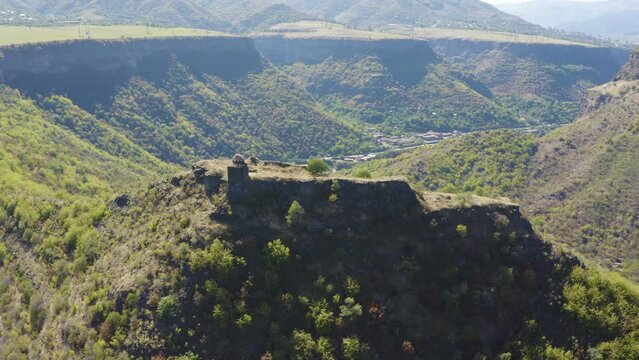 Forward reveal aerial shot of Kayan Fortress and Debed gorge on sunny summer day. Lori Province, Armenia.