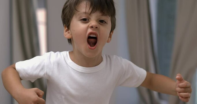 Intense Young boy venting anger in 800 fps slow-motion shout, angry kid yelling to camera