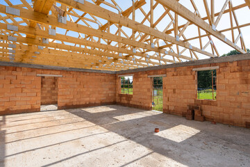 Unfinished family home with brick walls, attic, wooden roof