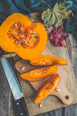 Autumn pumpkins and leaves on a wooden table.Autumn pumpkin thanksgiving background with pumpkins.Halloween.Thanksgiving