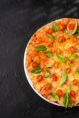 Margarita pizza with delicious fresh tomatoes - wooden background