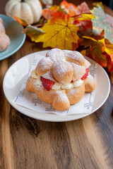 Delicious traditional mexican pan de muerto, filled with delicious cream, with red fruits inside, strawberries and blackberries.