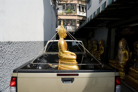 Thailand, Bangkok, Buddha Tied Down By It's Crown In The Bed Of A Truck.