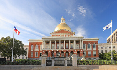 Massachusetts State House and State Library. Imposing red building with white columns and golden dome. 