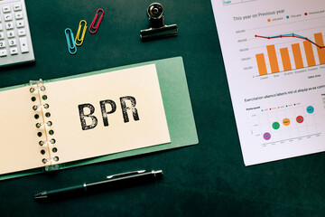 There is notebook with the word BPR. It is an abbreviation for Business Process Re-engineering as...