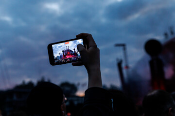 Smartphones in the Hands of the Crowd at an Outdoor Music Event.