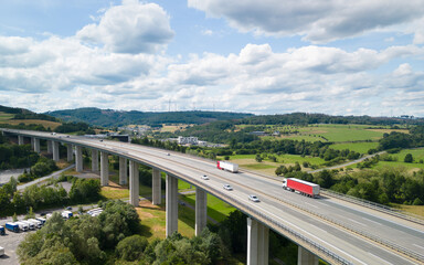 aerial view of a highway bridge going over the valley in the beautiful countryside