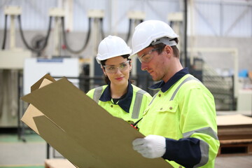 worker or engineer working in factory with safety uniform , safety hat and safety glasses , image is safety concept or happy workplace