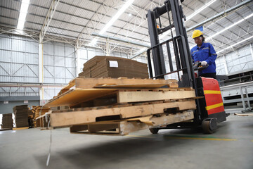 worker or engineer working in factory with safety uniform , safety hat and safety glasses , image is safety concept or happy workplace