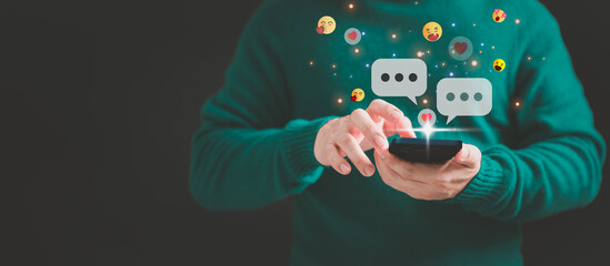 Young man using a smartphone with social media, typing live chat chatting on application communication digital web and social network concept. Social media application chat box.