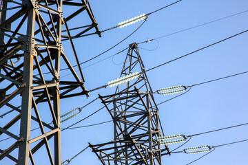power line support with wires for electricity transmission. High voltage grid tower with wire cable at distribution station. Energy industry.
