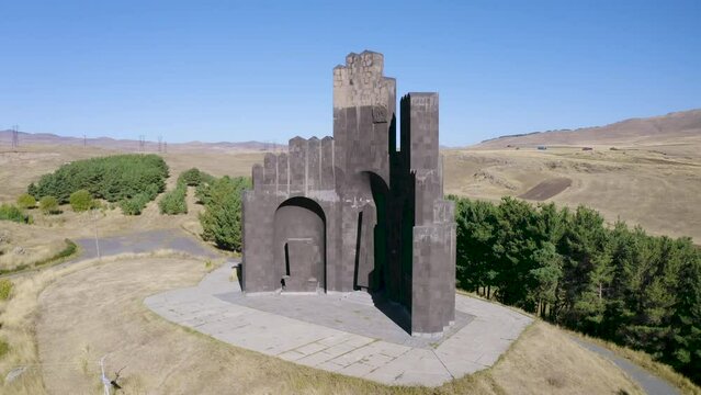 Orbital aerial shot of Aparan Battle Monument (Dro memorial) on sunny summer day. Aparan, Aragatsotn Province, Armenia.