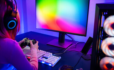 Woman wear gaming headphones playing live stream esports games console at home, Gamer using joystick controller for virtual tournament plays online video game with computer neon lights