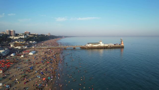 Too Many People At Bournemouth Beach Who Are Enjoying British Hot Day Of Summer. England Great Britain UK. Footage Captured With Drone's Camera On September 9th, 2023 During Sunset