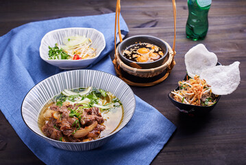 Pan-Asian dish setup on the dark table
