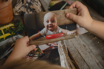 Photo printing concept. Toddler hands hold printed photo.