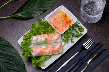 Shrimp summer roll. Asian dish composition on a dark table top view