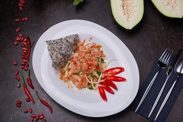 Fried prawns with chili. Pan-asian dish on dish top view on a dark table