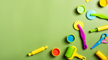 Plasticine or clay play dough tools activity set for children on a green background. Molding stack,...